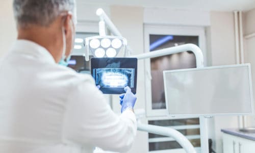 dentist examines x-ray